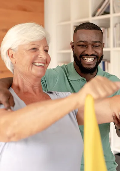 Caregiver assisting senior exercise